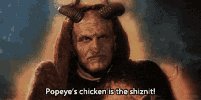 a devil with horns says popeye 's chicken is the shiznut