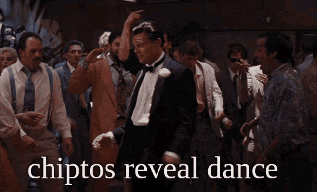 a man in a tuxedo is dancing in front of a crowd with the words chiptos reveal dance on the bottom
