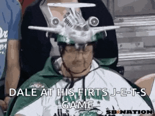 a man is wearing a hat with an airplane on it .
