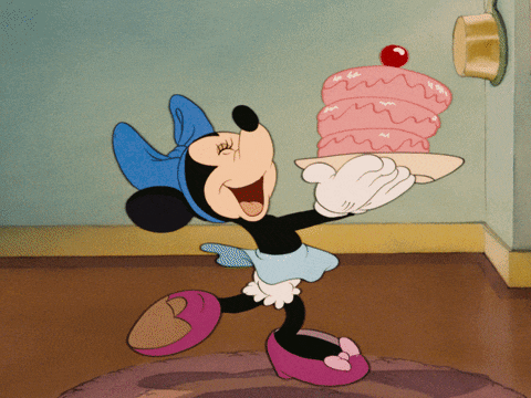 a cartoon of minnie mouse holding a pink cake on a tray