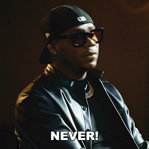 a man wearing a hat and sunglasses says " never "