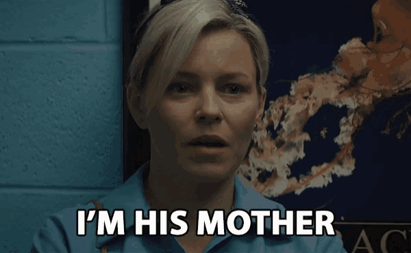 a woman says i 'm his mother in front of a blue wall