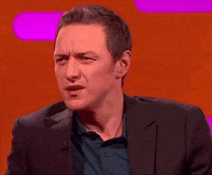 a man in a suit is making a funny face on a red background