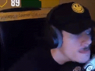a person wearing a black hat with a yellow smiley face on it