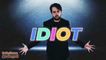 a man with his arms outstretched is standing in front of the word idiot