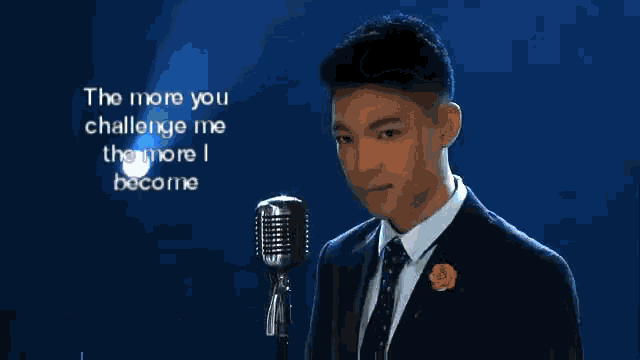 a man in a suit sings into a microphone