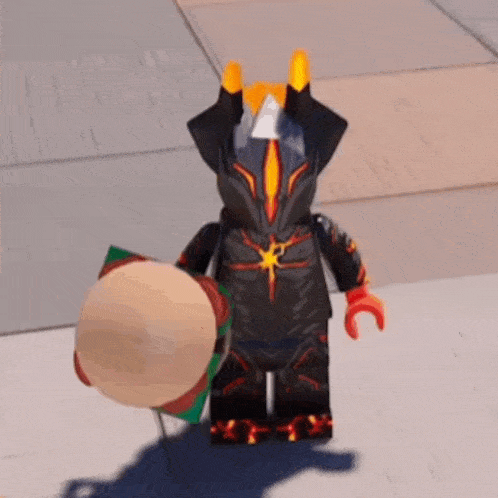 a lego figure is standing on a sidewalk holding a hamburger .