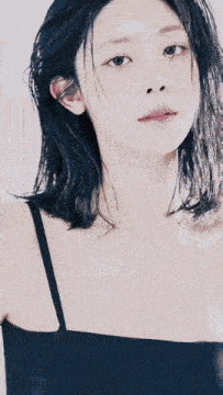a close up of a woman 's face with black hair