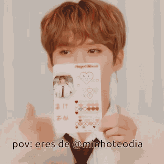 a man is holding a card that says angel heart on it