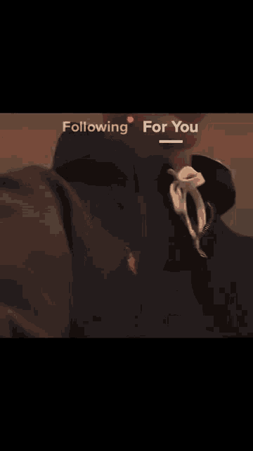 a blurry picture of a man 's face with the words `` following for you '' written on it .