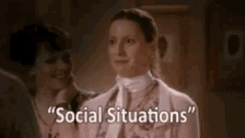 a woman in a pink jacket and white tie is talking about social situations while standing next to another woman .