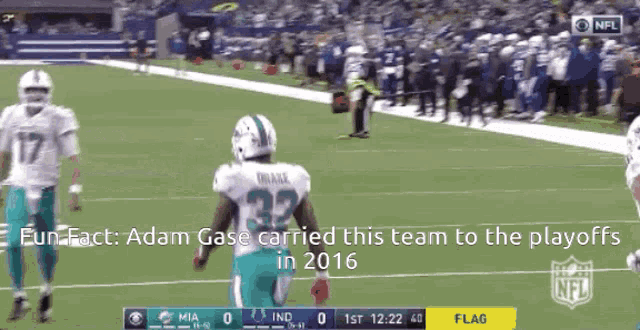 a miami dolphins football player wearing number 32 runs on the field