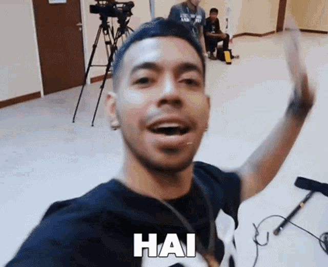 a man taking a selfie with hai written on the bottom