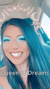 a woman with blue hair is wearing a tiara and smiling ..