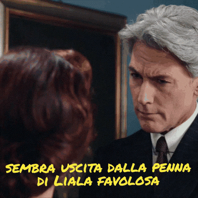 a man in a suit and tie is looking at a woman with the words sembra uscita dalla penna di liala favolosa