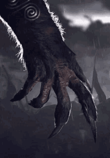 a close up of a monster 's hand with a lightning strike in the background .