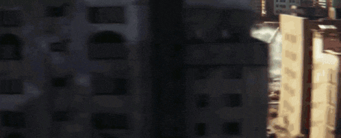 a blurry picture of a building with a swimming pool in the background .
