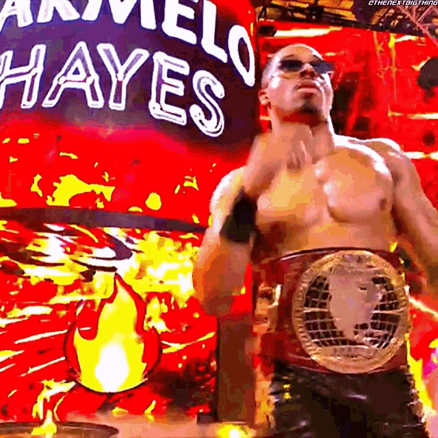 a shirtless wrestler is standing in front of a sign that says marvel hayes