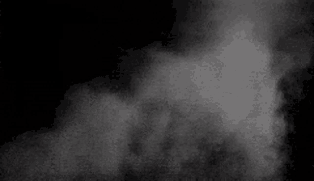 there is a lot of smoke coming out of the bottom of the screen on a black background .