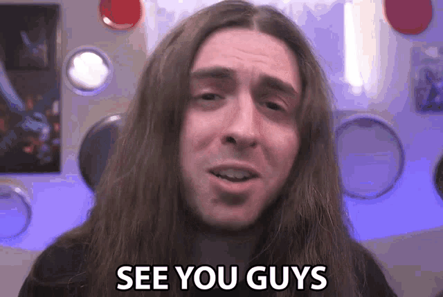 a man with long hair saying see you guys