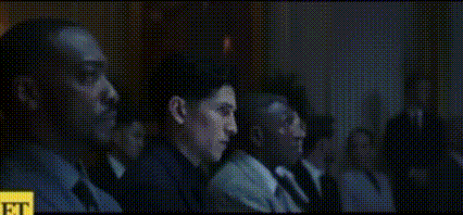 a group of people are sitting in a dark room in a movie theater .