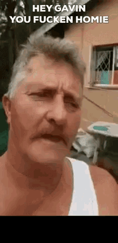 a man with a mustache says hey gavin you fucken homie in front of a house