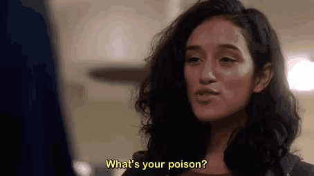 a woman is talking to another woman and asking her what 's your poison .