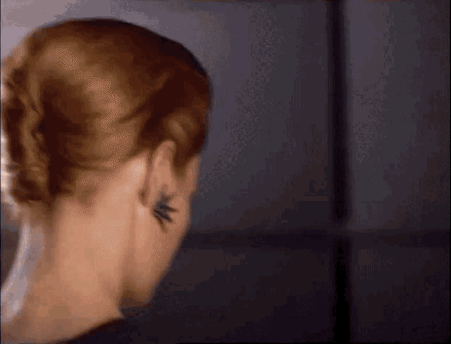 a woman with a tattoo on her ear