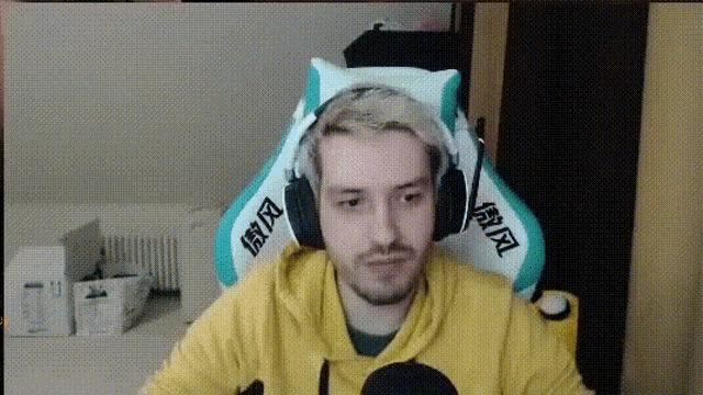 a man wearing headphones is sitting in a chair .