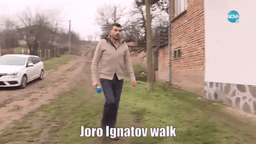 a man is walking down a dirt road with the words " joro ignatov walk " written on the bottom