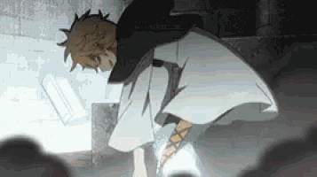 a man in a white robe is standing in a dark room with a sword in his hand .