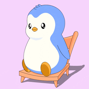 a blue and white penguin sits on a chair