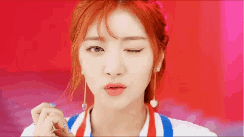 a close up of a woman with red hair making a funny face