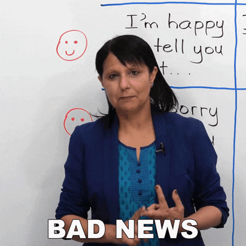 a woman stands in front of a white board that says i 'm happy tell you sorry bad news