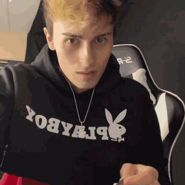 a young man wearing a black hoodie that says yobyabox