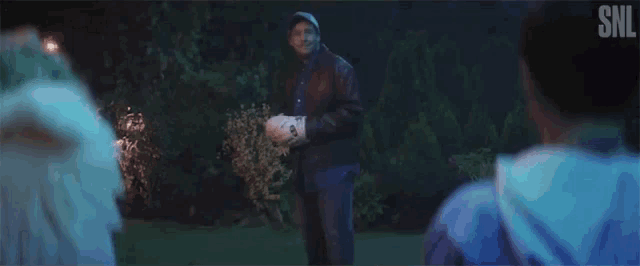 a man is holding a ball and says okay cool .