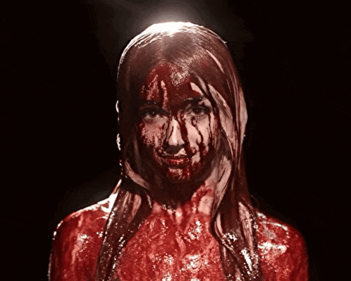 a woman with blood dripping from her face and body