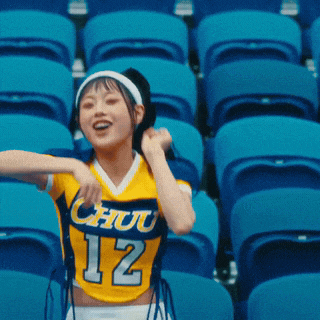 a cheerleader wearing a yellow shirt with the number 12 on it
