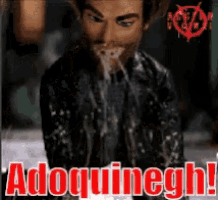 a man is covered in liquid and says " adoquinegh " on the bottom