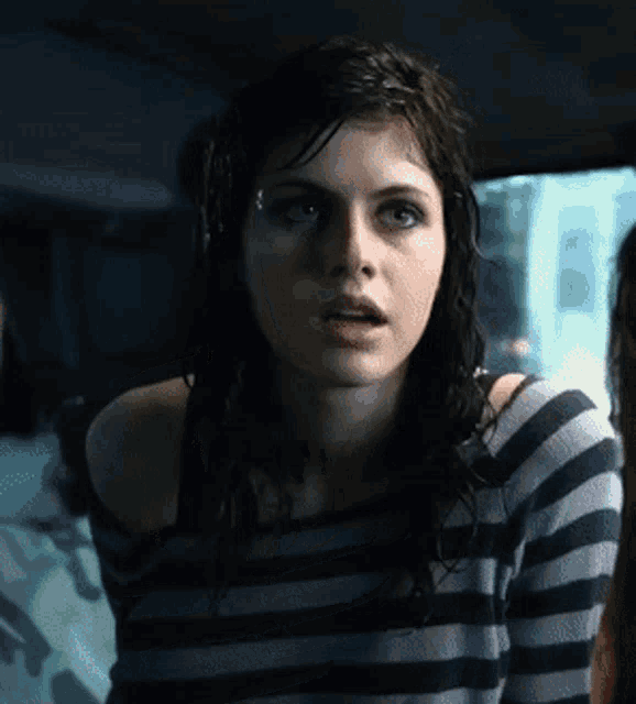 a woman in a striped shirt looks very surprised