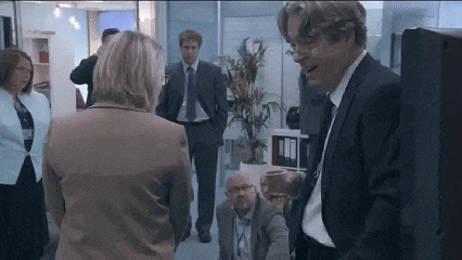 a man in a suit is talking to a woman