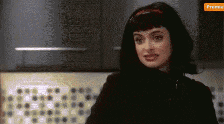 a woman with black hair and a red headband is looking at the camera with a popup that says premiu