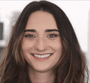 a close up of a woman 's face smiling