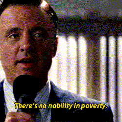 a man speaking into a microphone with the words " there 's no nobility in poverty " in yellow letters