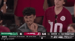 a man wearing a red shirt with the number 10 on it yawning