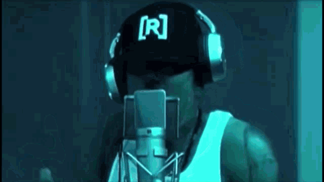 a man singing into a microphone with headphones on
