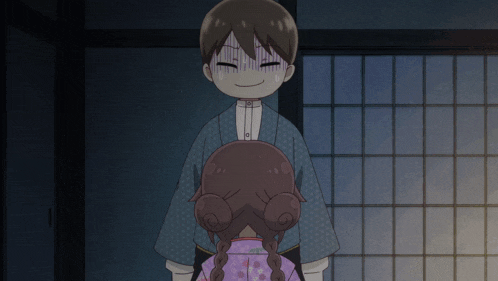 a boy in a kimono stands next to a girl in a pink kimono
