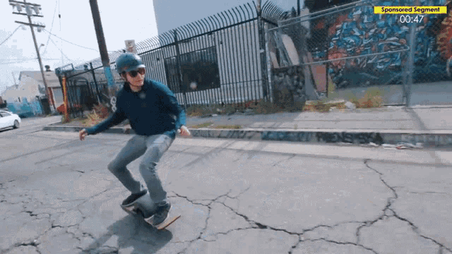 a man is riding a skateboard down a street with sponsored segment 00:47
