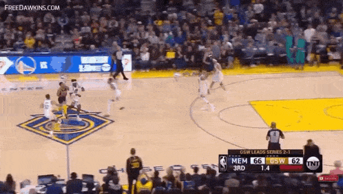 a basketball game is being played in front of a crowd with a scoreboard that says tnt on it