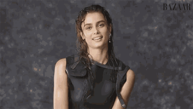 a woman in a black dress with the name taylor hil
